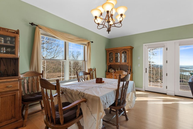 dining area featuring a chandelier and light hardwood / wood-style flooring