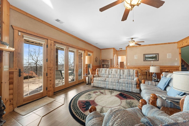 living room featuring ornamental molding, ceiling fan, and light hardwood / wood-style flooring