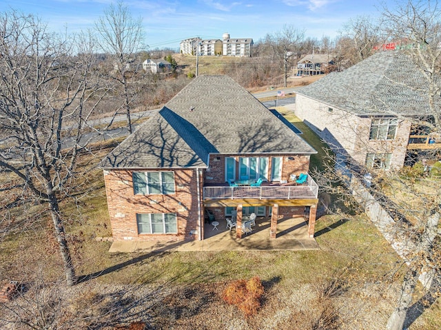 rear view of house featuring a patio area and a deck