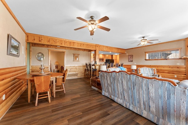 living room with dark wood-type flooring, ceiling fan, and ornamental molding