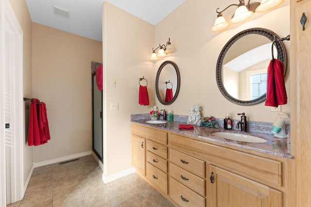 bathroom featuring vanity, tile patterned flooring, and a shower with door