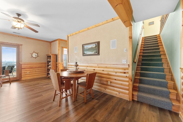 dining area featuring crown molding, log walls, ceiling fan, and hardwood / wood-style flooring