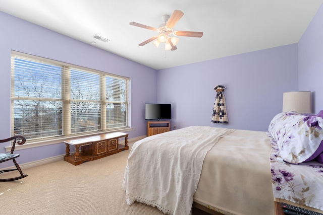 bedroom with ceiling fan and light colored carpet