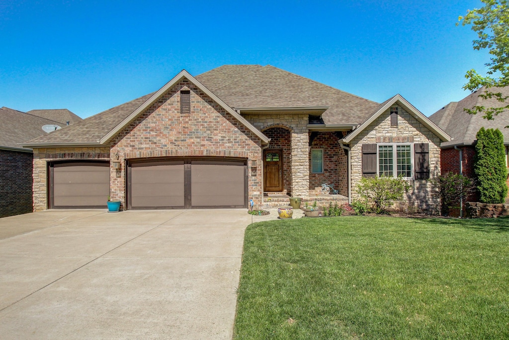 view of front of property with a garage and a front lawn