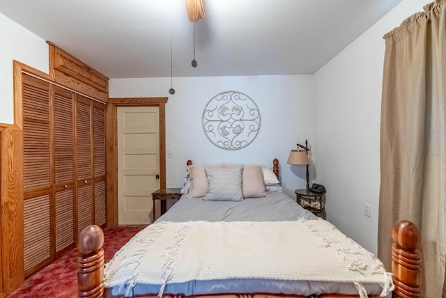 carpeted bedroom featuring ceiling fan and a closet