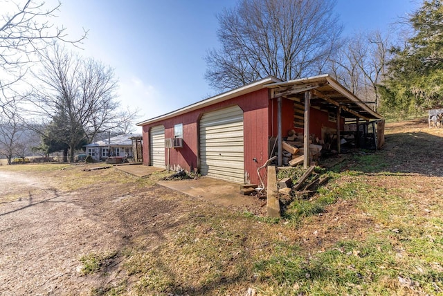 view of outbuilding with cooling unit and a garage