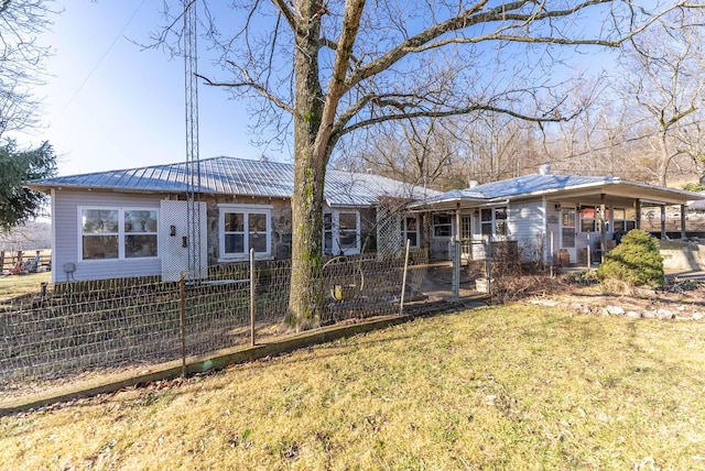 back of property with a yard and a carport