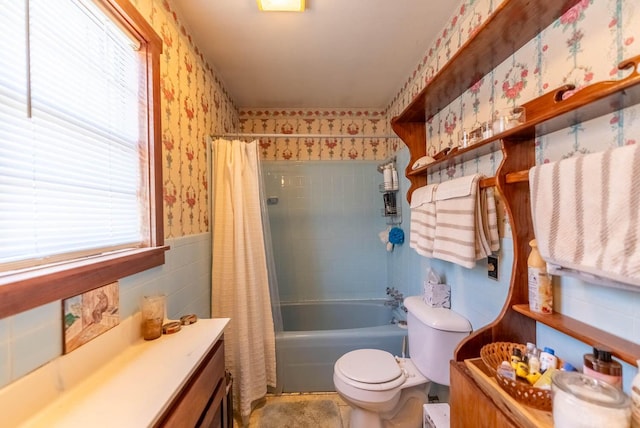 full bathroom with vanity, toilet, tile walls, and shower / bath combo