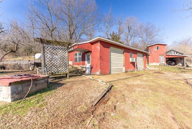 exterior space with a garage and cooling unit