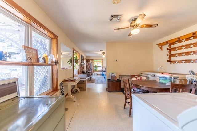 dining room with ceiling fan and washer / dryer