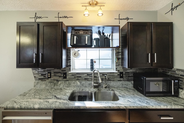 kitchen featuring sink, dishwasher, backsplash, dark brown cabinets, and a textured ceiling