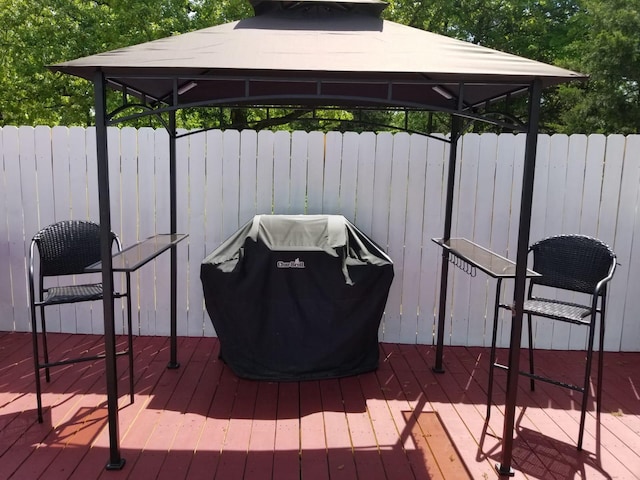 wooden terrace with a gazebo and grilling area