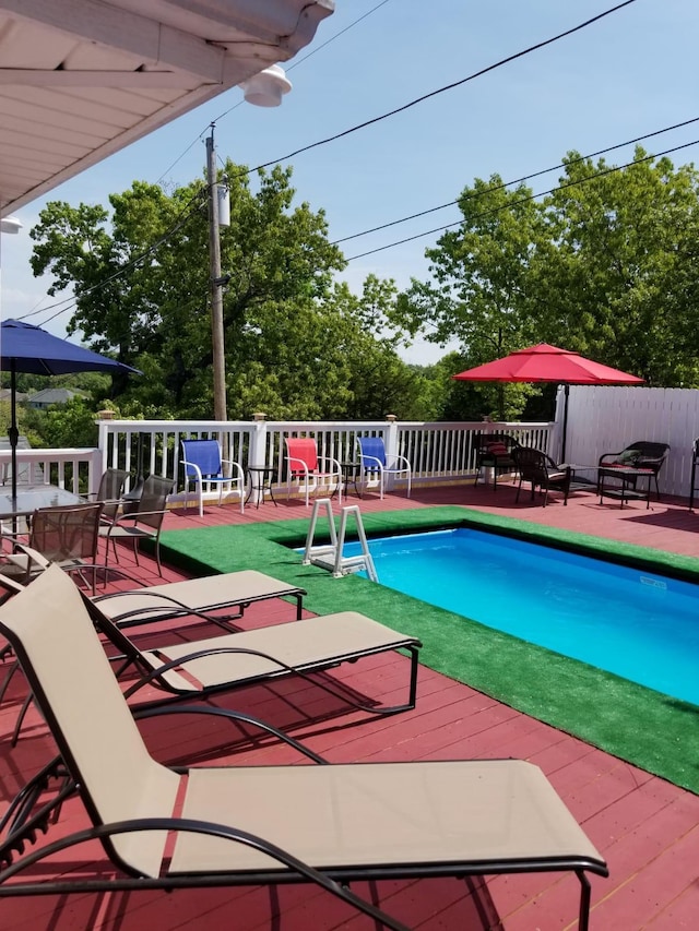 view of swimming pool with a deck