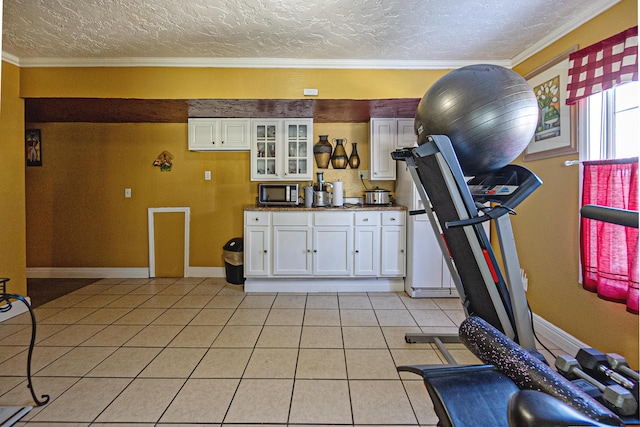 exercise area with light tile patterned flooring, crown molding, and a textured ceiling