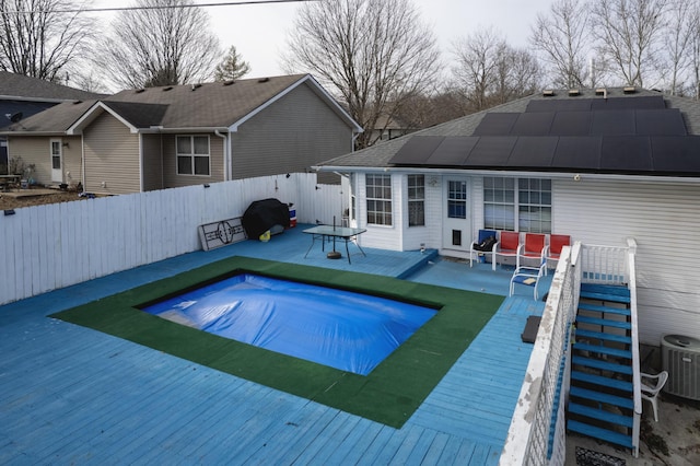 view of swimming pool with central AC, a deck, and grilling area