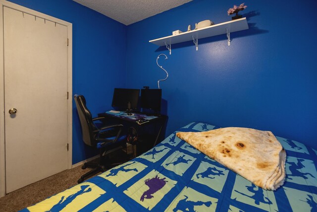 bedroom with a textured ceiling and carpet