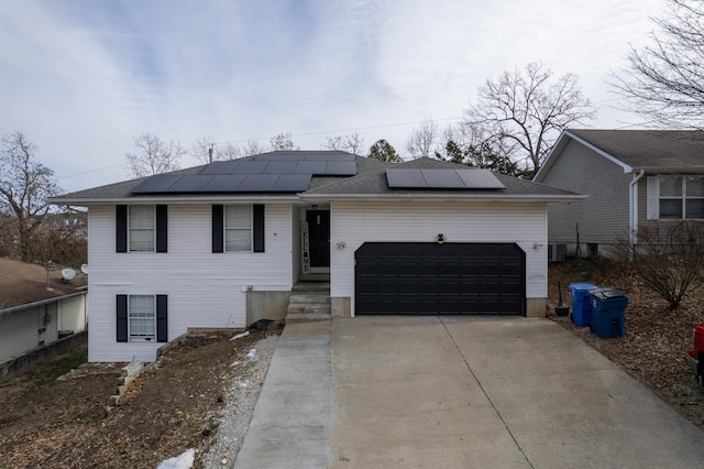 view of front of home with a garage and solar panels