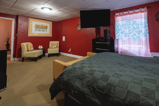 carpeted bedroom with a paneled ceiling