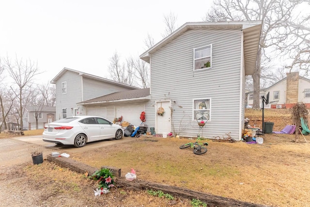 exterior space with a garage and a front lawn