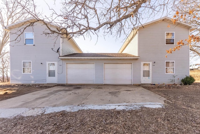 rear view of property featuring a garage