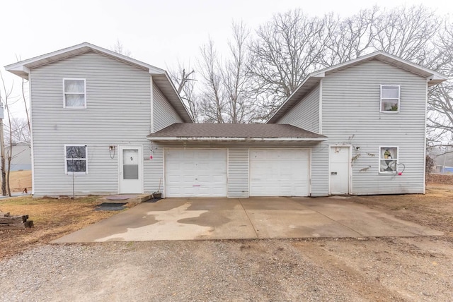 rear view of house featuring a garage