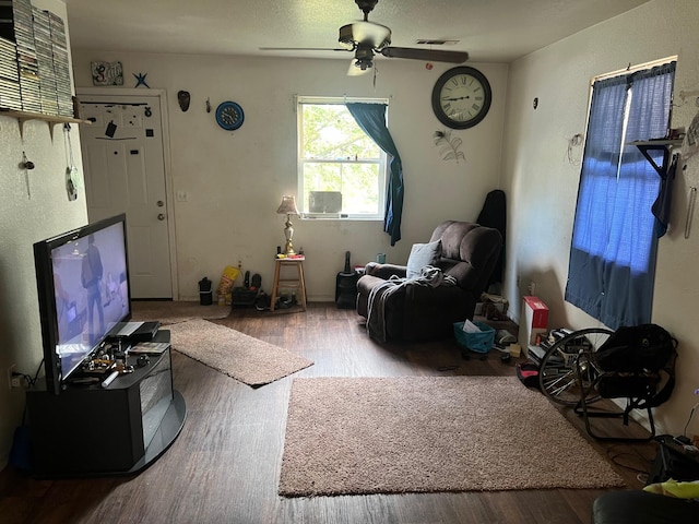 living room featuring hardwood / wood-style flooring and ceiling fan