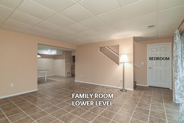 basement with a paneled ceiling, tile patterned floors, and pool table