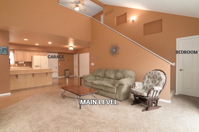 living room with high vaulted ceiling, light hardwood / wood-style floors, and ceiling fan