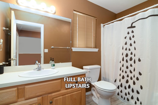 bathroom featuring vanity, a shower with curtain, and toilet