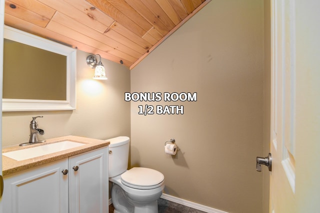 bathroom featuring vanity, vaulted ceiling, wood ceiling, and toilet