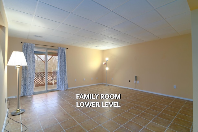 tiled spare room with a paneled ceiling