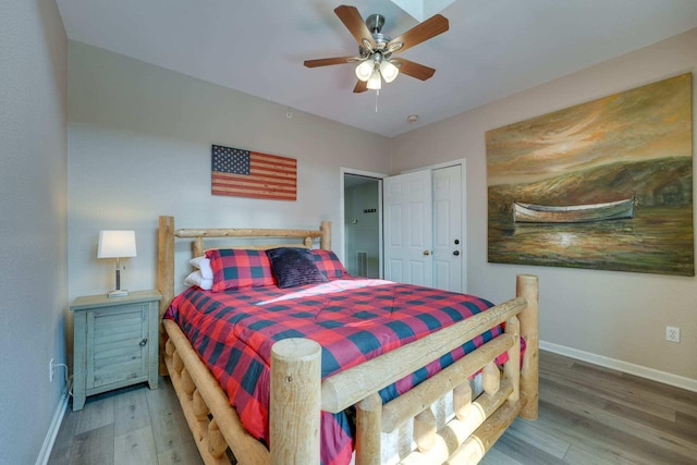 bedroom with hardwood / wood-style flooring, a closet, and ceiling fan