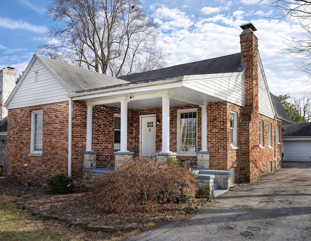 view of front of property with a porch and a garage