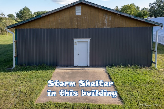 view of outbuilding with a lawn