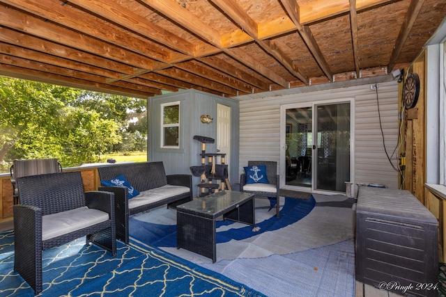 view of patio with a wooden deck and an outdoor living space