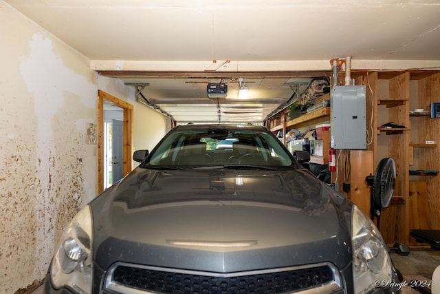 garage with a garage door opener and electric panel