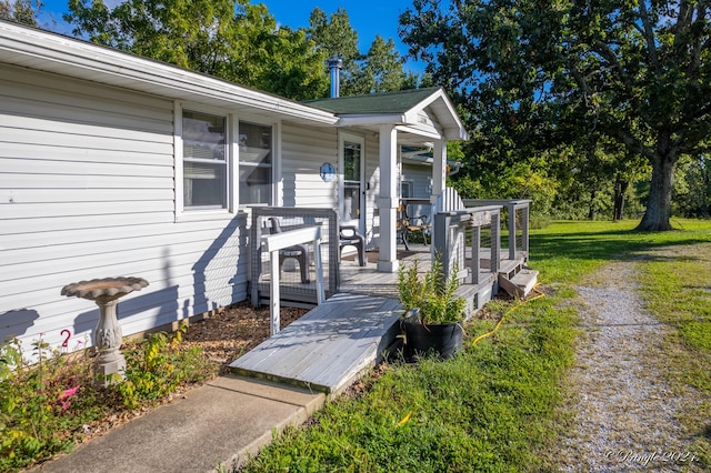 doorway to property with a yard