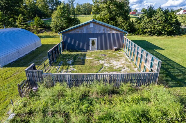 exterior space featuring an outdoor structure and a lawn