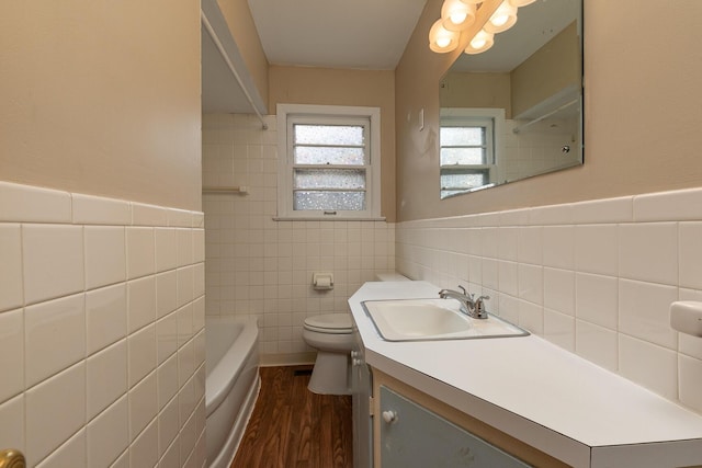 bathroom featuring hardwood / wood-style floors, vanity, tile walls, and toilet