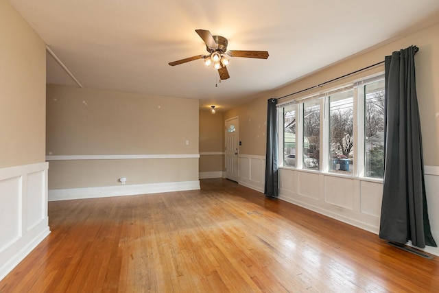 empty room featuring ceiling fan and light hardwood / wood-style floors