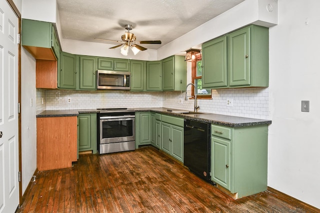 853 E Guinevere St, Springfield, MO 65807 - kitchen featuring appliances with stainless steel finishes, a sink, a ceiling fan, dark wood finished floors, and decorative backsplash