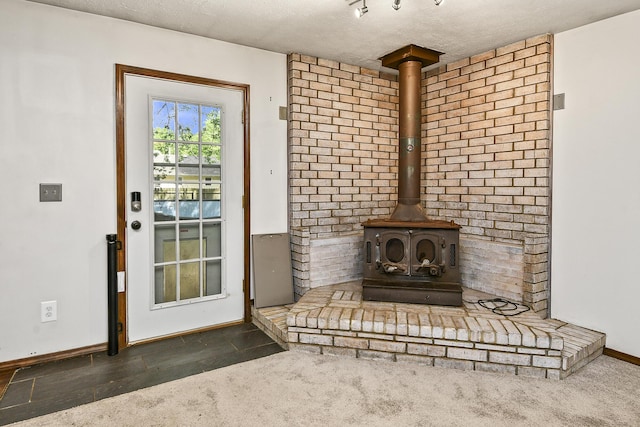 853 E Guinevere St, Springfield, MO 65807 - detailed view of a wood stove, baseboards, and a textured ceiling
