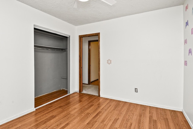 853 E Guinevere St, Springfield, MO 65807 - unfurnished bedroom with light wood-type flooring, a closet, a textured ceiling, a ceiling fan, and baseboards