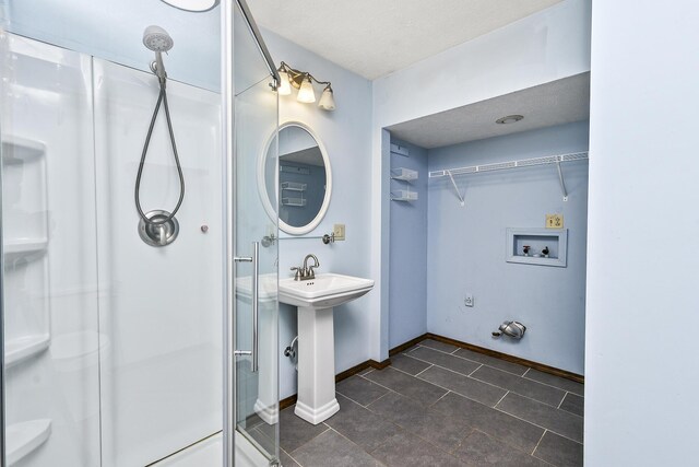 853 E Guinevere St, Springfield, MO 65807 - bathroom with a shower stall, tile patterned flooring, baseboards, a spacious closet, and a textured ceiling