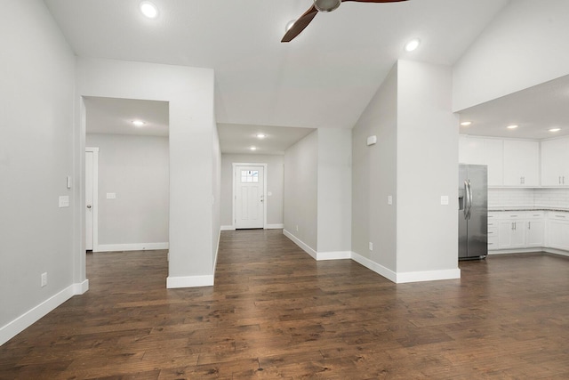 interior space with ceiling fan, dark hardwood / wood-style flooring, and vaulted ceiling