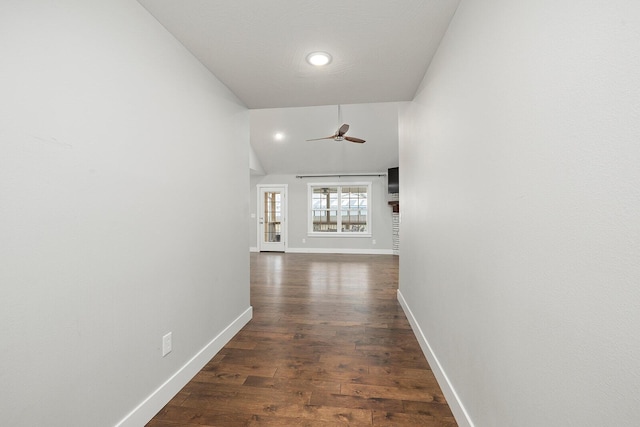 hall with dark hardwood / wood-style flooring and vaulted ceiling