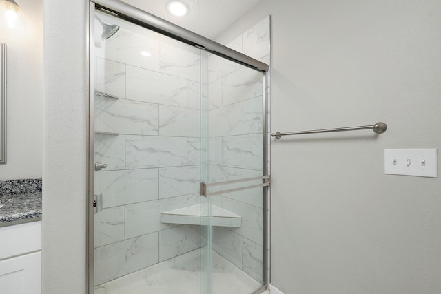 bathroom featuring vanity and an enclosed shower