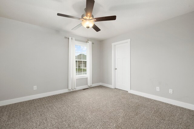 empty room with carpet and ceiling fan