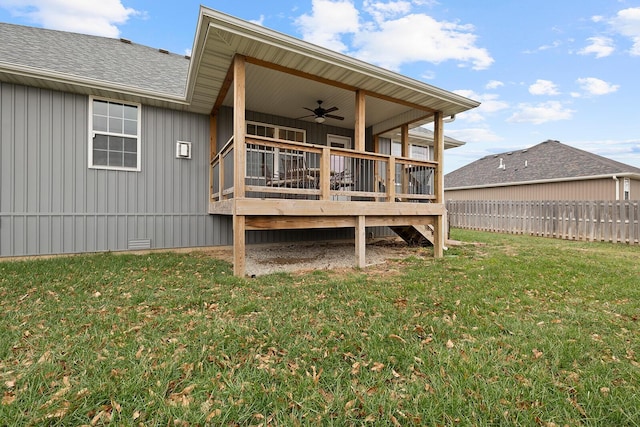 rear view of property with a yard, ceiling fan, and a deck