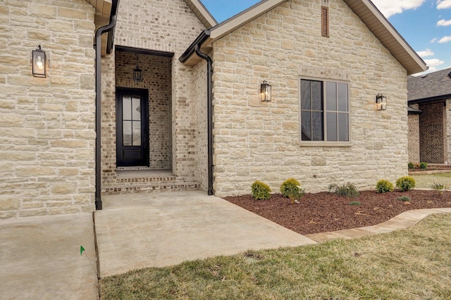 view of exterior entry featuring a patio area